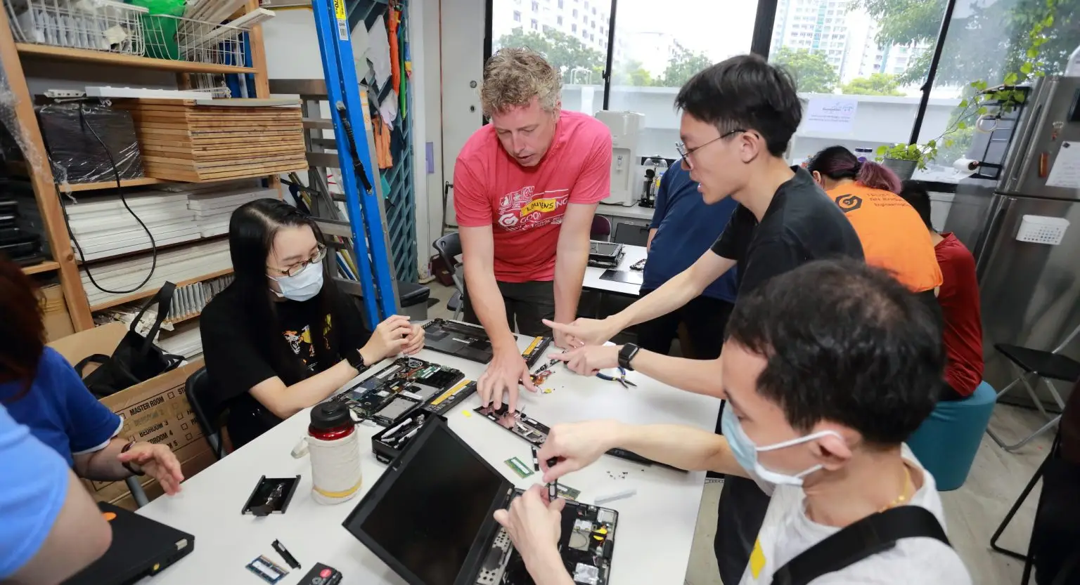 Volunteers at Engineering Good, a tech and engineering charity in Singapore, refurbishing laptops for vulnerable and low-income communities.