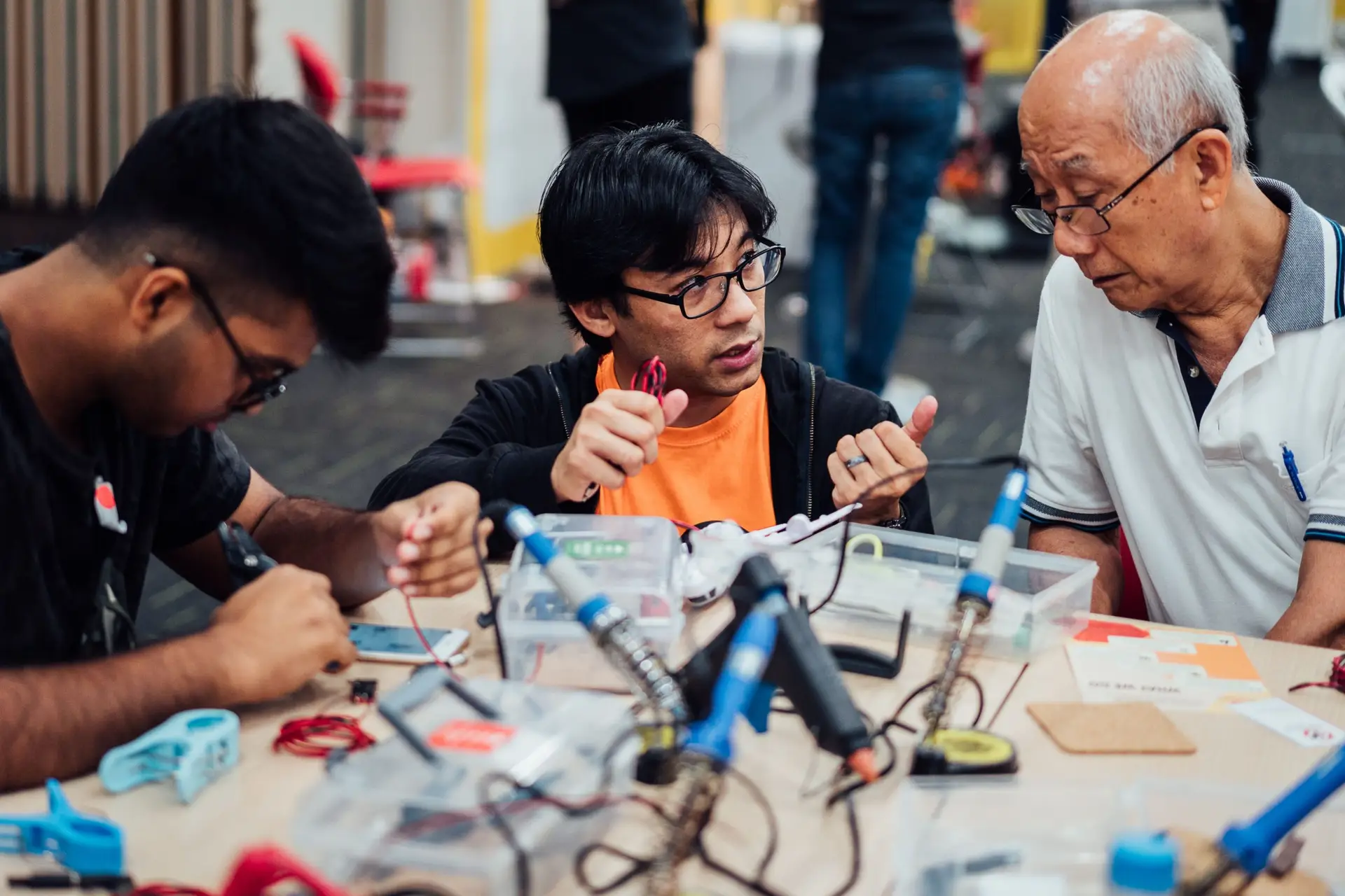 Engineering Good volunteer and an elderly man at an assistive technology workshop. EG is a tech and engineering charity in Singapore that empowers vulnerable and low-income communities, serving over 200 social service agencies.